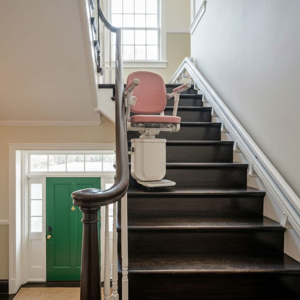 Stairlift on dark stairs next to green door